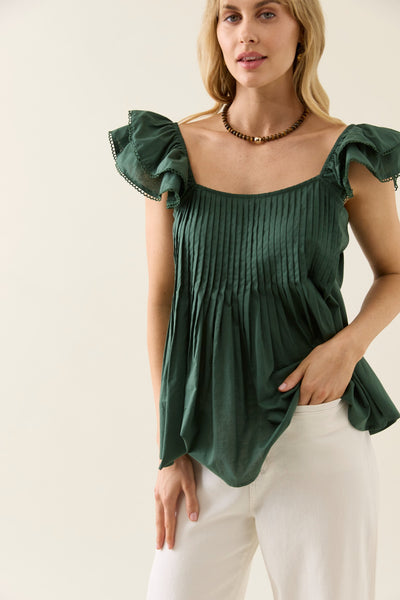 Model wearing Aurora Frill Tank Myrtle khaki green, close-up of neckline and frilled shoulders.
