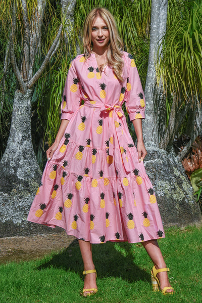 Woman wearing the Coop Pineapple Palms dress standing outdoors.