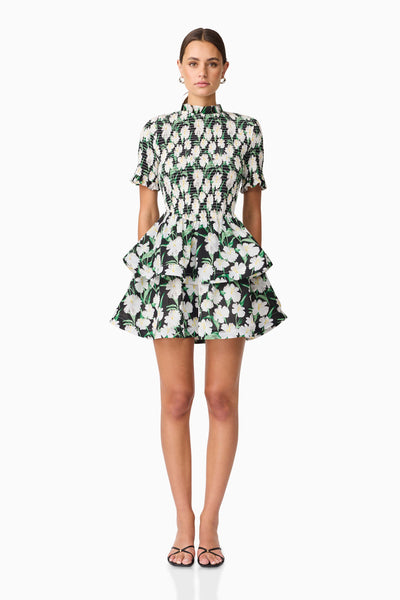 Model wearing the Rosey Short Sleeve Mini Dress in a floral pattern with a white background