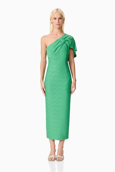 Woman wearing Theodara green one-shoulder dress on a white background