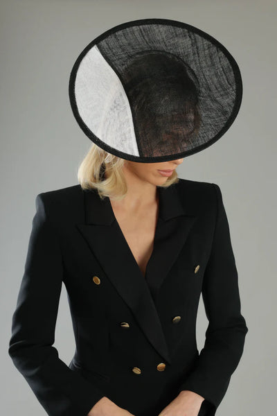 Close-up of Niah Plate Fascinator Black & White  on model showing monochrome panel and abaca weave