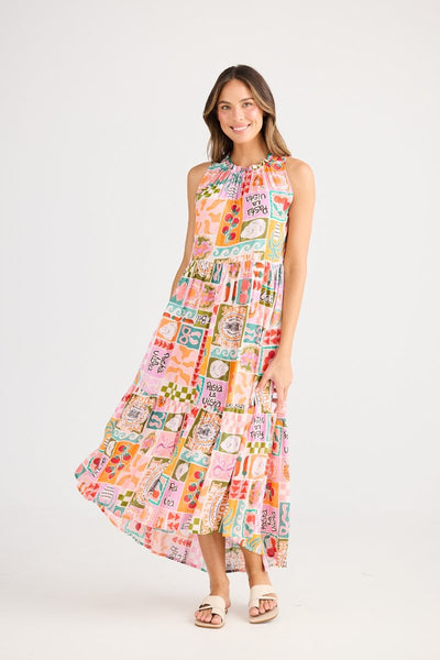 Smiling model in the Margot Dress Sardinia Summer by Holiday – relaxed fit summer dress with gathered neckline and fully lined lightweight fabric.