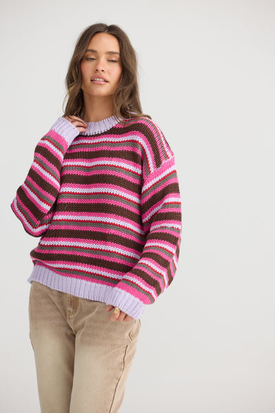 Allsorts Knit by Talisman worn by model  with natural coloured jeans on a white background.