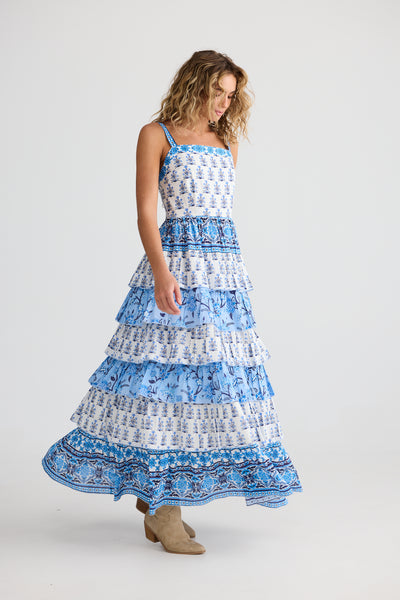 Model wearing Paloma Dress Blueberry Fields by Talisman – tiered blue and white midi dress with straight neckline and wide straps.