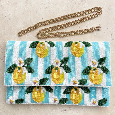 Anna Nova Lemon Stripe Beaded Clutch featuring yellow lemon beading on aqua and white striped background with detachable gold chain – available at Binny Bowe Boutique.
