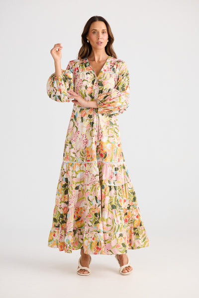 Model wearing Brave + True Gertie Dress Zoe’s Garden – full length floral button-up dress with balloon sleeves