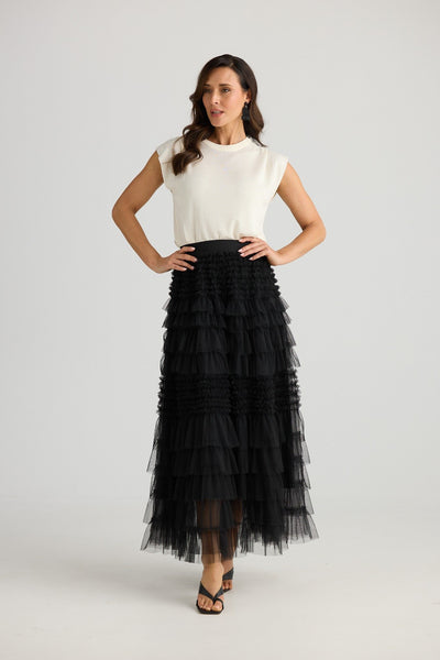 Model wearing Brave + True Soprano Skirt Black – maxi length tulle skirt styled with white top