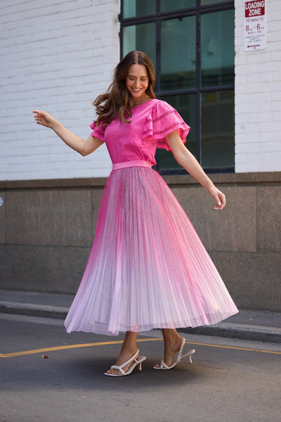 Model walking in Brave + True West End Skirt Hot Pink Ombre – event wear statement skirt