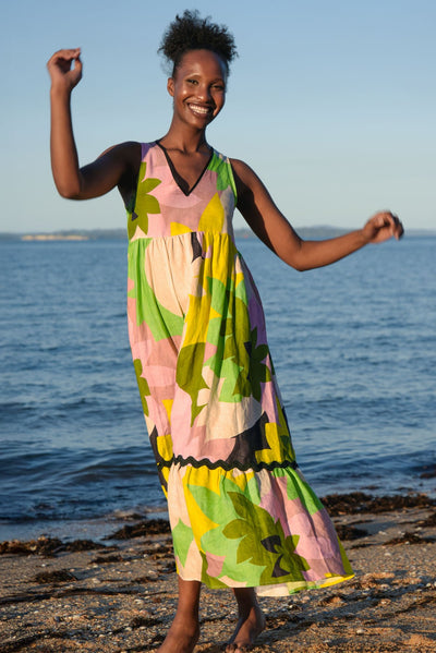 Model wearing Curate Ahead of the Game Dress Floral standing on the beach