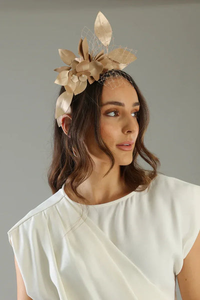 Front view of Morgan & Taylor Dulcie Headpiece in elegant gold, floral detailing and netting – shop racewear at Binny Bowe Boutique.