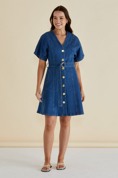 Front view of woman wearing Fiori Denim Dress in mid-wash by Betty Basics with button-up V-neck and belt