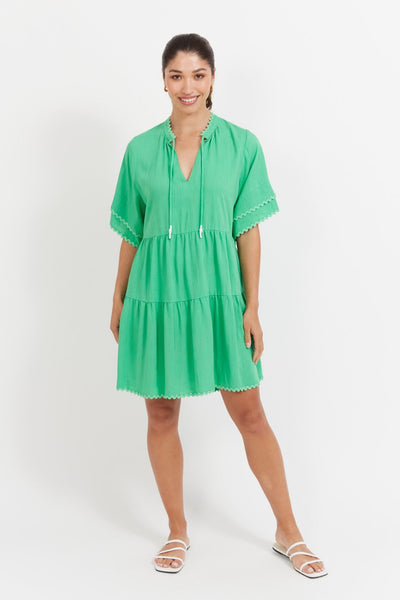 Model wearing Haven Haiti Dress Green with V-neckline and ric-rac detailing front view