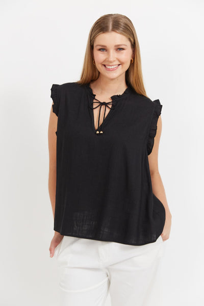 Front view of Jardin Top Black from Haven with ruffle neckline and gold-tie detail