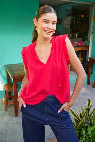 Model wearing Jardin Top Garnet from Haven styled with denim pants