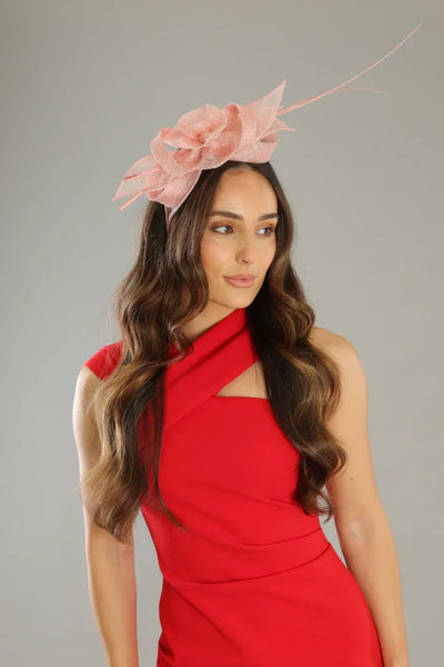 Woman wearing Judy Fascinator Pink by Morgan & Taylor – elegant racewear fascinator with sculptural bow detail.