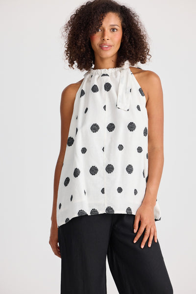 Front view of the Lucia Top in woven spot print, halter neck with side tie and floaty fit.