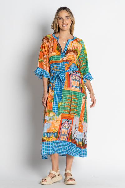 Woman wearing the Lanthea Midi Dress in vibrant multi print by Lulalife, featuring a relaxed A-line fit, below elbow-length flounce sleeves, collar band with button tab, side pockets, and an optional waist tie. The dress displays a colourful digital pattern and is made from 100% viscose.