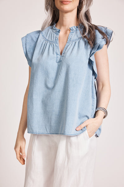 Model wearing Eb&Ive Melenia Denim Frill Top in light denim, featuring V-neckline, frill sleeves, and relaxed fit, perfect for casual chic everyday style.