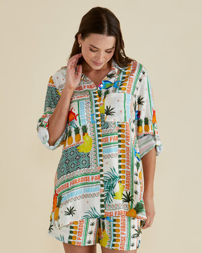 Model wearing Mills Shirt Paradise Print from Betty Basics – front view, button-up collar, long sleeves, Paradise tropical print.