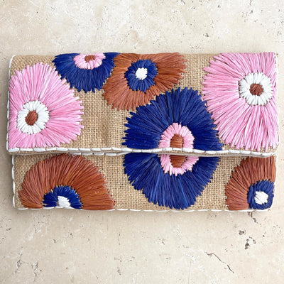 Front view of Raffia Detail Clutch Floral Bloom by Anna Nova with pink, blue, and brown floral design.