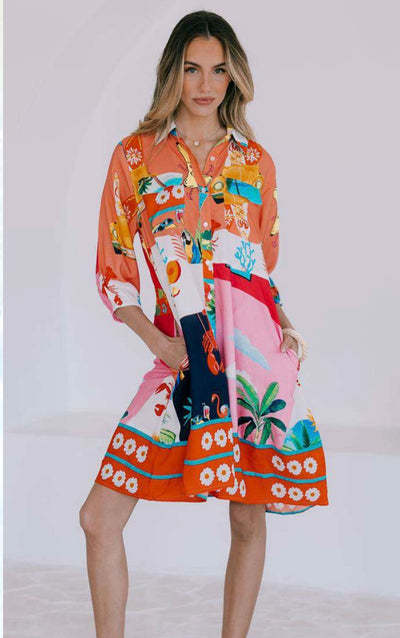 Model wearing the San Sabastian Relaxed Shirt Dress with bold tropical print, front view.