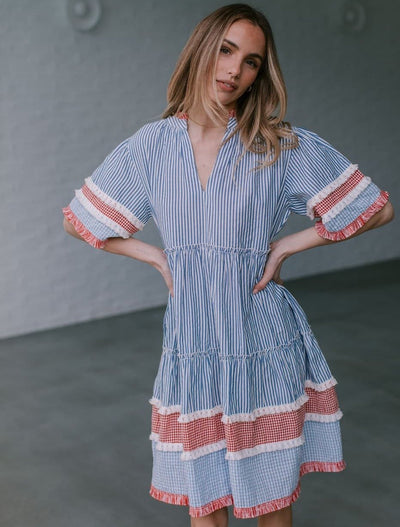 Whisky Bar Striped Dress from Joop & Gypsy – blue and white striped dress with red gingham and fringe detailing.